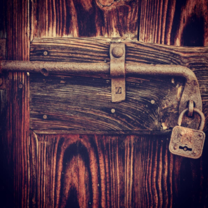 Door secured with bar and padlock